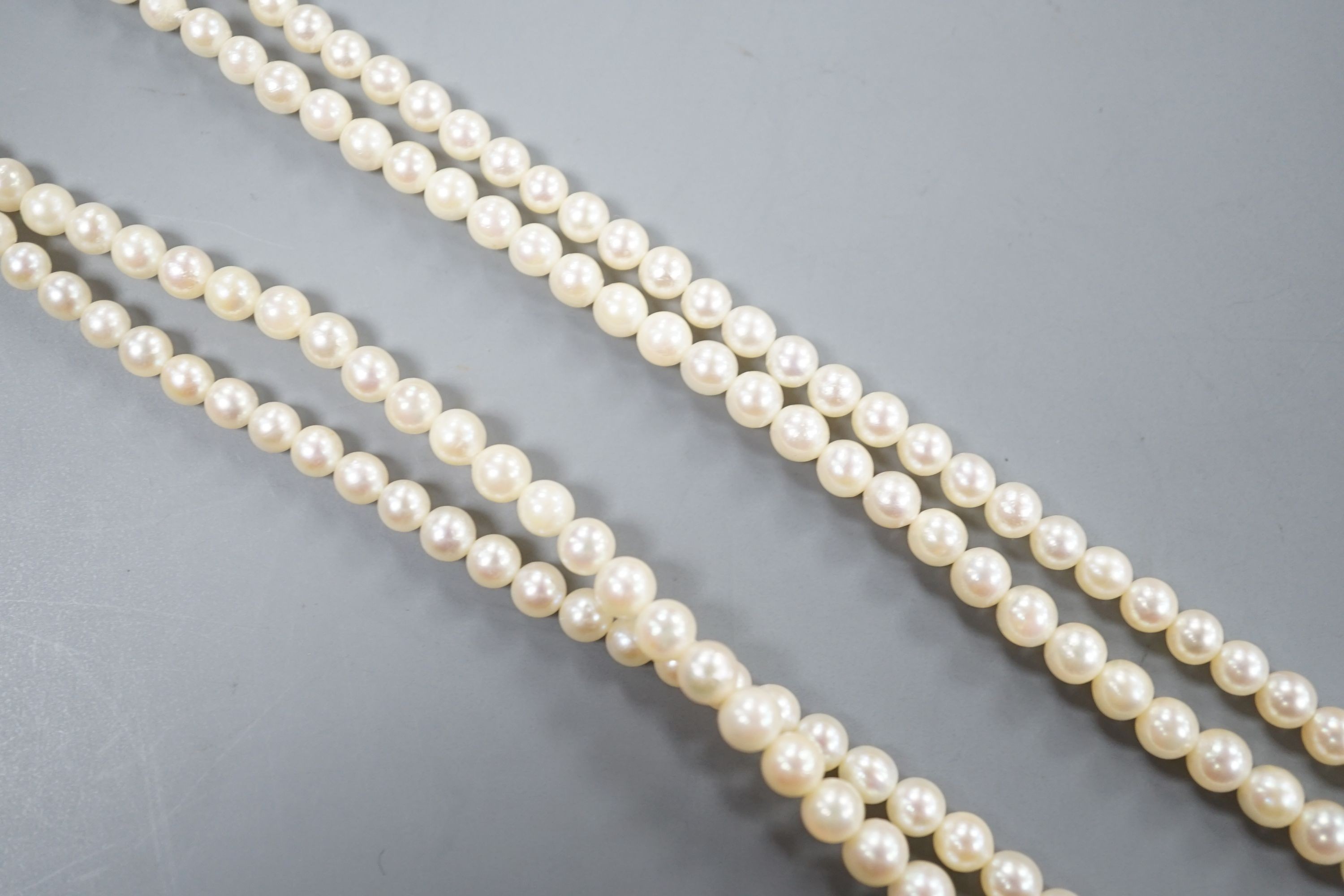 A double strand graduated cultured pearl necklace, with a 9ct and cultured pearl set clasp, 44cm.